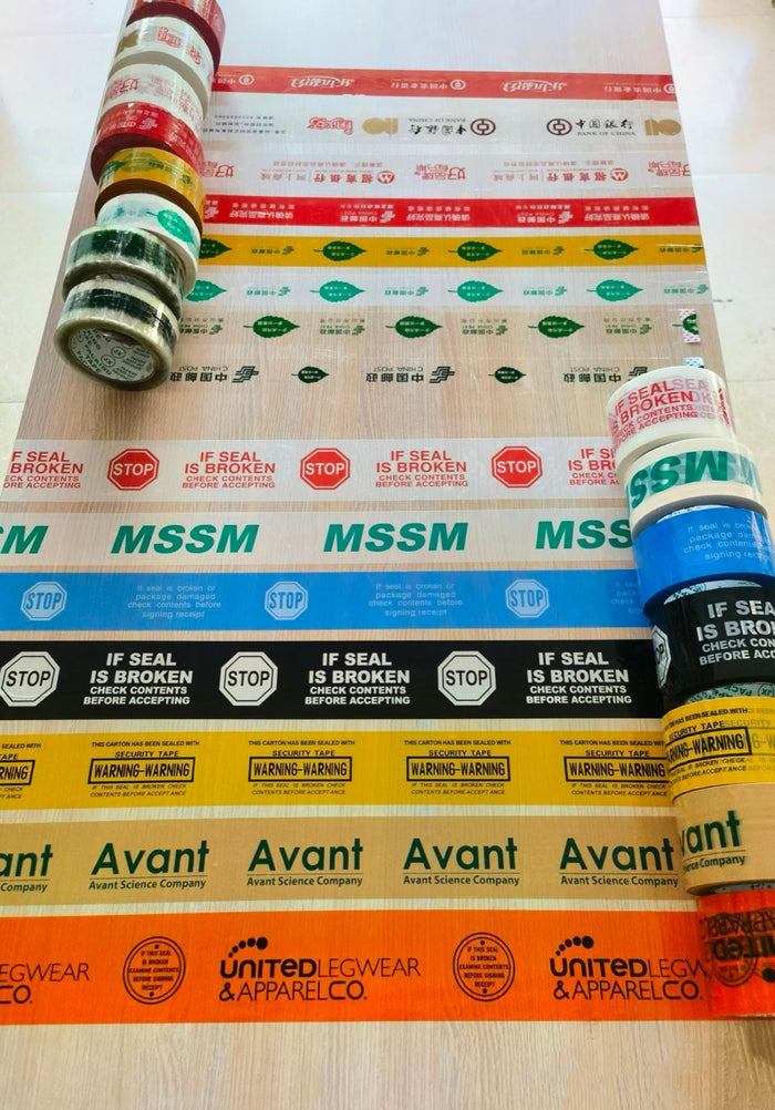 Colored custom security tape and printed warning tape samples displayed on a table