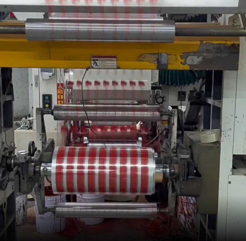 Custom printed tape running through a printing roller during production