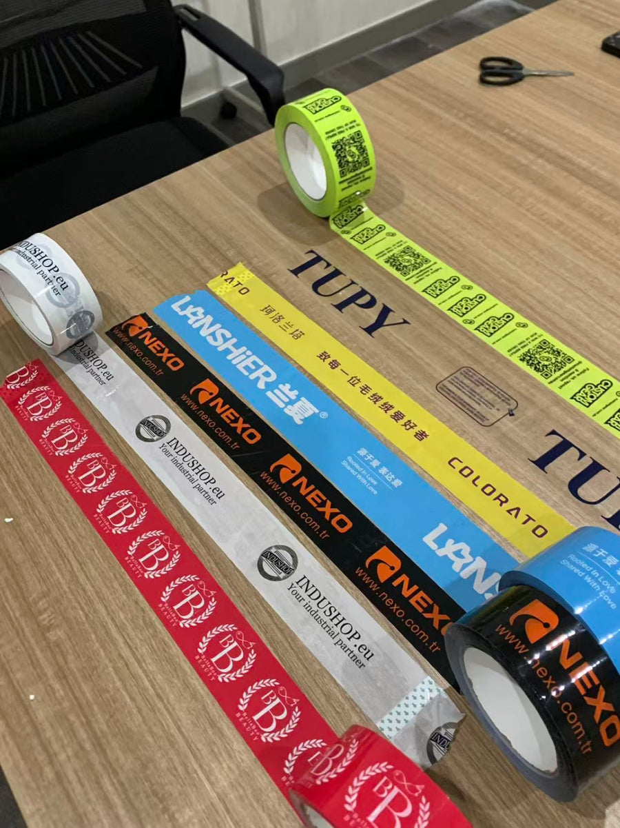 Real custom printed packing tape samples displayed on a table